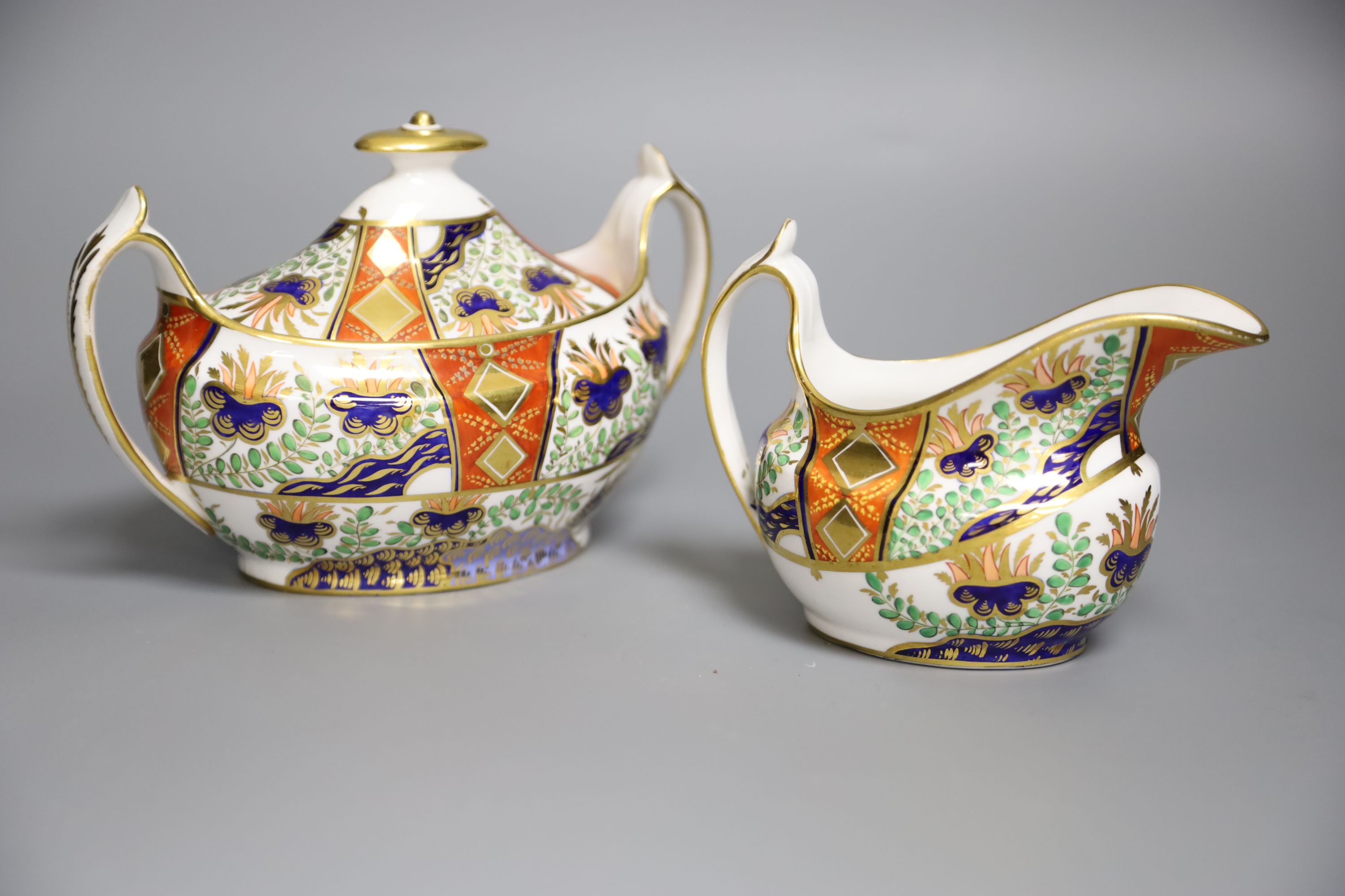 A Spode sucrier and cover painted in imari style with pattern 2213 and a matching 2213 cream jug